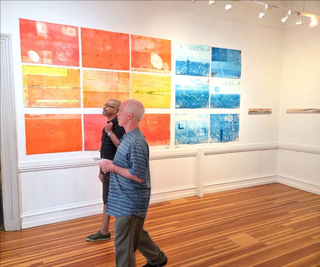 Darryl and Carl walk through art exhibit.
